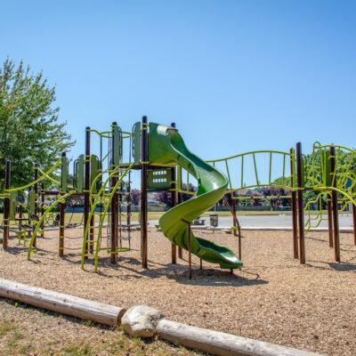 green playground on woodchip surfacing