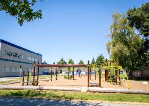 brown and green playground on woodchip surfacing