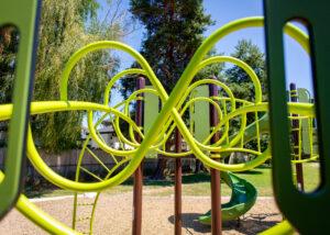 brown and green playground on woodchip surfacing