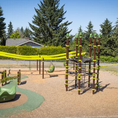 brown and green playground on woodchip surfacing