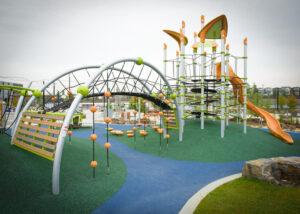 green playground on blue and green rubber surfacing