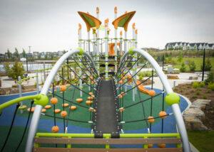 green playground on blue and green rubber surfacing