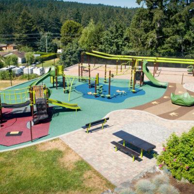 brown and green playground on rubber surfacing