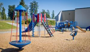 red and blue school playground on woodchips