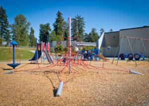 red and blue school playground on woodchips