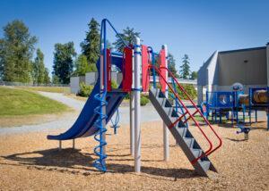 red and blue school playground on woodchips