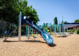 silver blue and green playground on woodchips