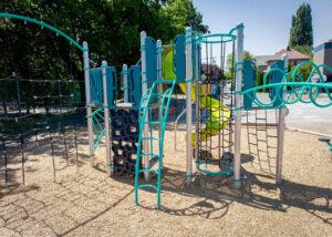 silver blue and green playground on woodchips