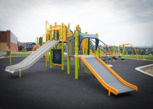 green playground on black rubber surfacing