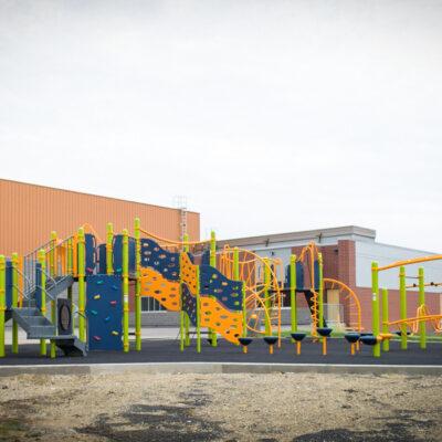 green playground on black rubber surfacing