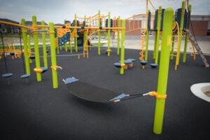 green playground on black rubber surfacing