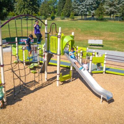 green and silver playground on woodchip surfacing