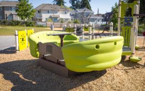 green and silver playground on woodchip surfacing