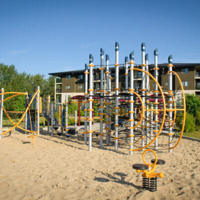 silver and yellow playground on rubber surfacing