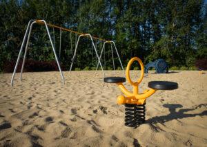 silver and yellow playground on rubber surfacing