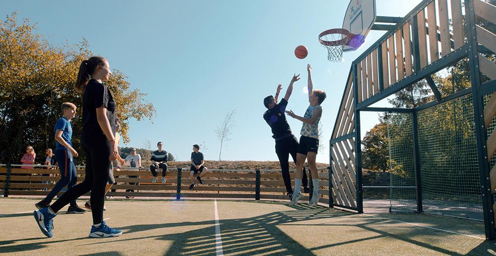 Children playing basketball in MUGA Courts