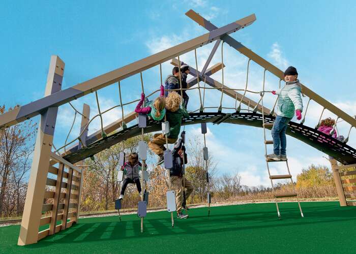 Angular brown and blue playground on green turf with children playing