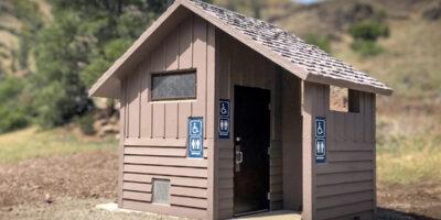 Board and batt upper walls, horizontal lap lower walls with cedar shake roof