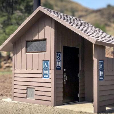 Board and batt upper walls, horizontal lap lower walls with cedar shake roof