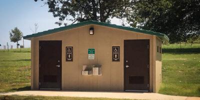 Single user flush washroom building in a park