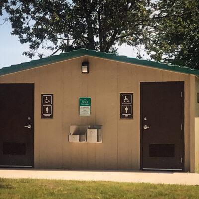 Single user flush washroom building in a park