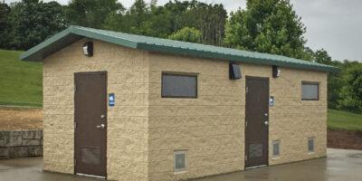 washroom building with Split face block walls wtih cedar shake roof