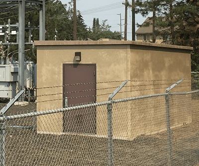 utility building with Stucco walls with flat roof
