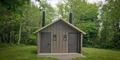 washroom building with Board and batt walls with cedar shake roof