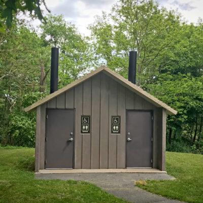 washroom building with Board and batt walls with cedar shake roof