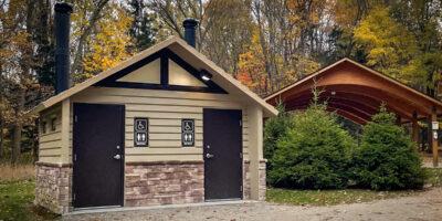 washroom building with Board and batt upper walls, napa valley rock lower walls with cedar shake roof