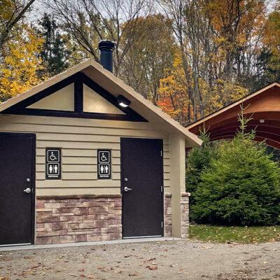 washroom building with Board and batt upper walls, napa valley rock lower walls with cedar shake roof