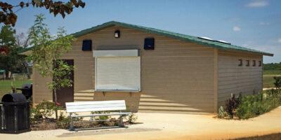 concession building with Horizontal lap walls with cedar shake roof