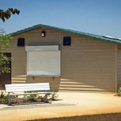 concession building with Horizontal lap walls with cedar shake roof