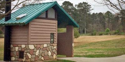 washroom building with Flagstone lower walls, horizontal lap upper walls with cedar shake roof