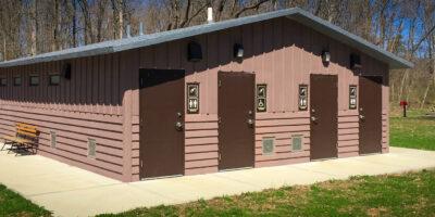 shower building with Board and batt upper walls, horizontal lap lower walls with cedar shake roof