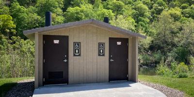 washroom building with Board and batt walls with cedar shake roof