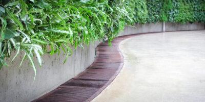 Image of Metal Grate Castings on concrete with greenery above