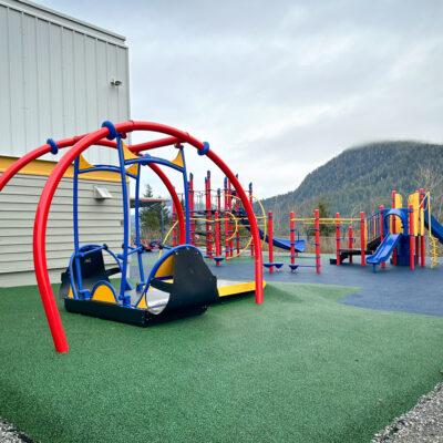 Red blue and yellow playground on rubber surfacing