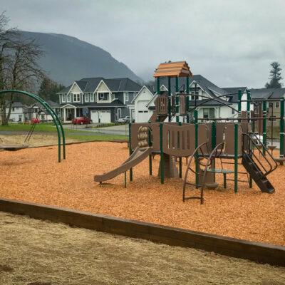 brown and green playground with engineered wood fibre (EWF) surfacing