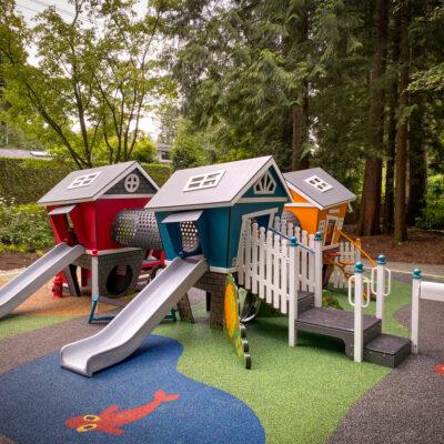 smart play centre (white, yellow, red and blue play structure) on marathon pour-in-place rubber (PIP) surfacing