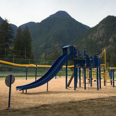 blue and yellow playground on engineered wood fibre (EWF) surfacing
