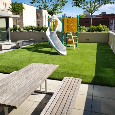 gray, yellow and green play-structure on artificial turf