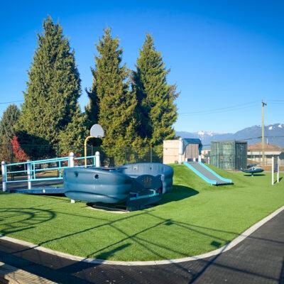 light and dark blue play structures on artificial turf
