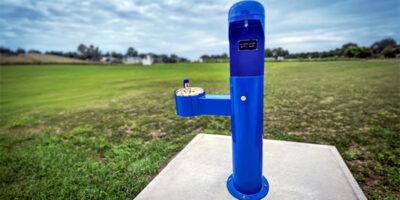 blue water fountain in a field