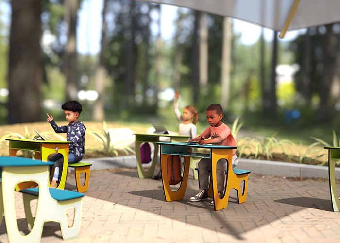children sitting in outdoor desks