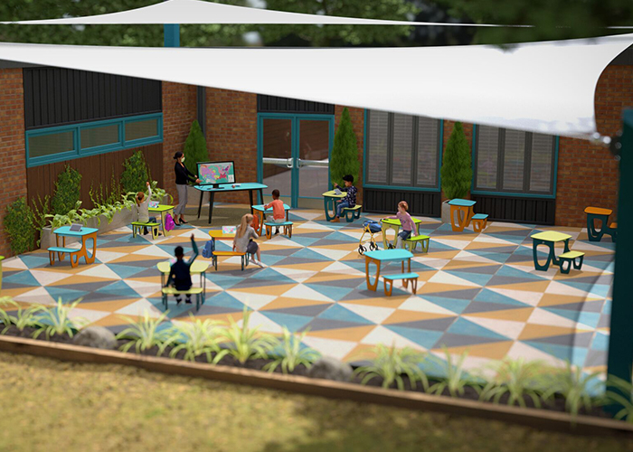 children sitting in outdoor desks