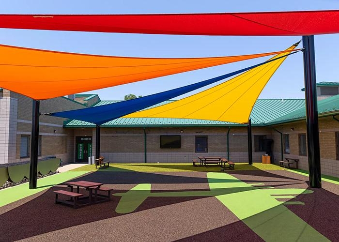 Outdoor classroom with big colourful shade sails