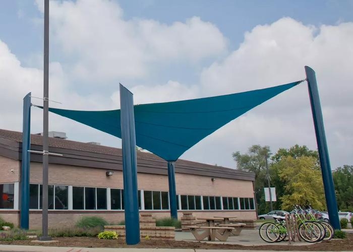 Outdoor classroom with big blue shade sails