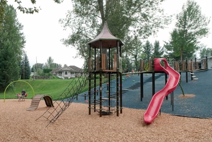 a tower at the bottom of a hill with access at the top of the hill