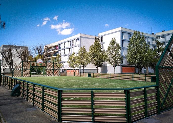 grass sports court with a track around it